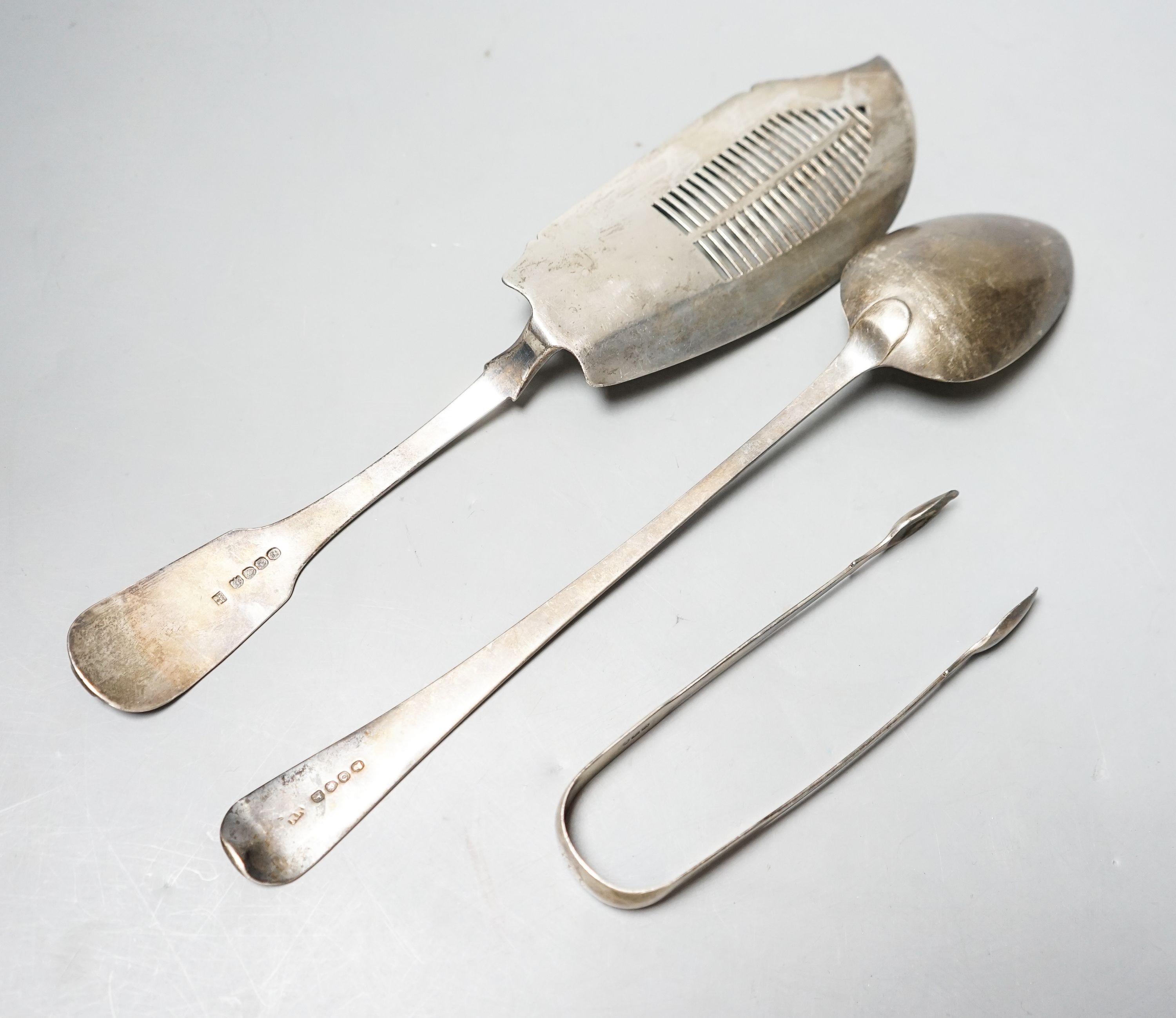 A late George III silver fiddle and shell pattern fish slice, London, 1819, a pair of silver sugar tongs and a George IV silver basting spoon, 9.5oz.